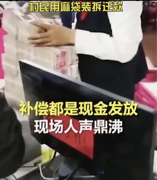 拆迁补偿现场村民用麻袋装现金画面